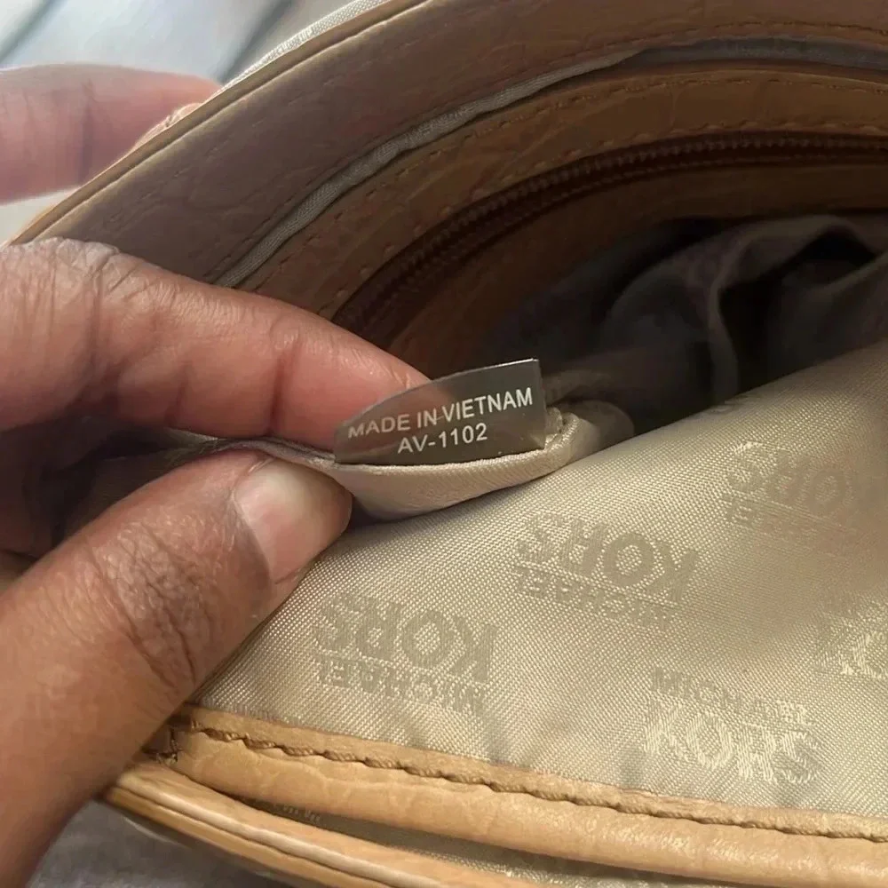 Tan Michael Kors envelope chain crossbody purse with adjustable straps